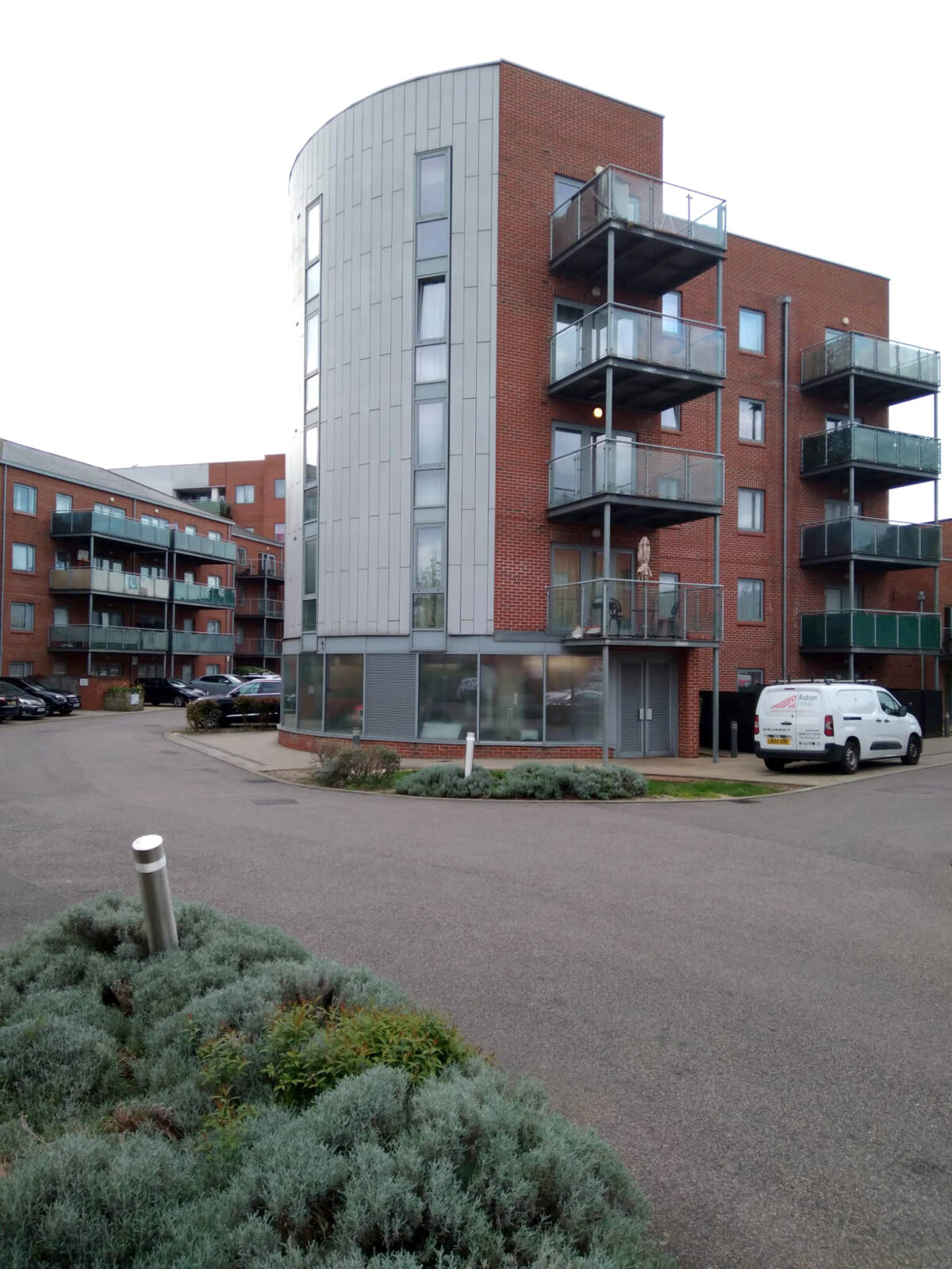 Aqua Court building exterior with an Aston Group van parked outside