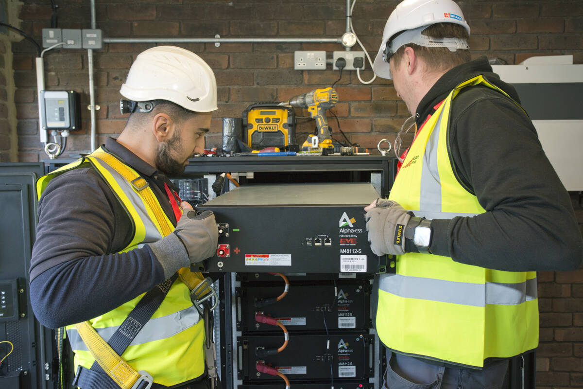 An image of two workers at Longfield House during Solar PV battery storage installation
